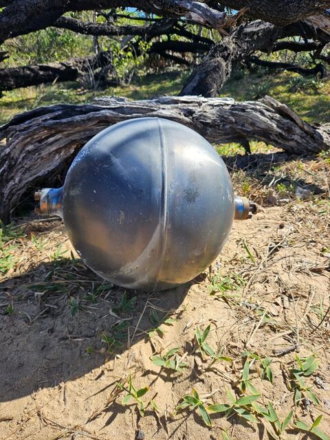 A mysterious sphere found on the beach, possibly space debris that re-entered Earth, Australia.